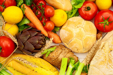 Wall Mural - A white kitchen table with various types of bread and vegetables