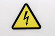 Yellow sigh danger electric shock with lightning in triangle on a metal door. Danger Electrical Hazard High Voltage Sign.  Close up