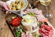 © Jérôme Rommé - Fromage chaud Mont d'or ou boite chaude accompagné de charcuterie et pommes de terre (spécialité du Jura, france)