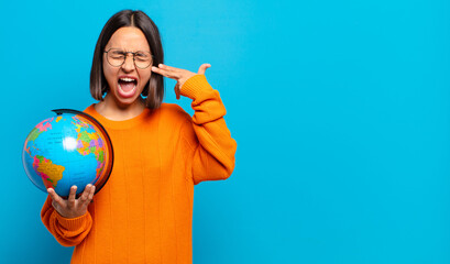 Wall Mural - young hispanic woman looking unhappy and stressed, suicide gesture making gun sign with hand, pointing to head