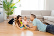 © Louis-Paul Photo - happy mother and father with baby daugter playing at home