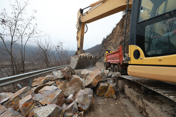 Elisseina, Bulgaria - February 2, 2021: Heavy chain and wheeled equipment clears the highway after a rock collapse near Elisseina station, Bulgaria