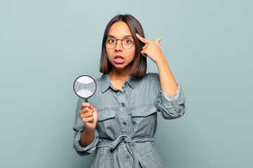 Canvas Print - young hispanic woman looking surprised, open-mouthed, shocked, realizing a new thought, idea or concept