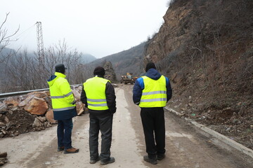 Elisseina, Bulgaria - February 2, 2021: Heavy chain and wheeled equipment clears the highway after a rock collapse near Elisseina station, Bulgaria