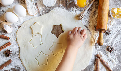 Wall Mural - A child makes a cookie. Selective focus.