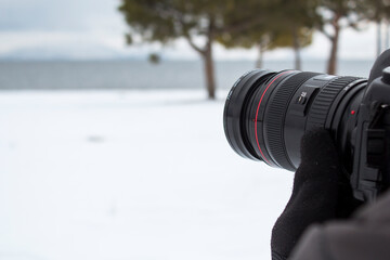 Wall Mural - photographer taking pictures of the lake in winter