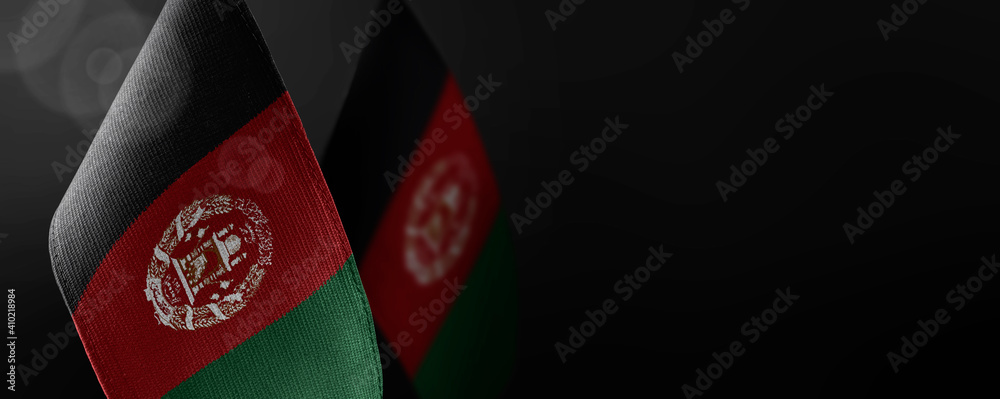 Obraz na płótnie Small national flags of the Afghanistan on a dark background w salonie