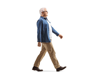 full length profile shot of a casual mature man walking