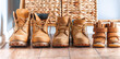 Happy home family concept. Small and big yellow boots together. Leather tourist boots. Shoes of father, mother and a child