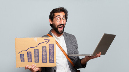 Wall Mural - young bearded and crazy businessman with a laptop