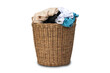 Clothes in a laundry wooden basket isolated on white background. Overflowing laundry basket. clipping path