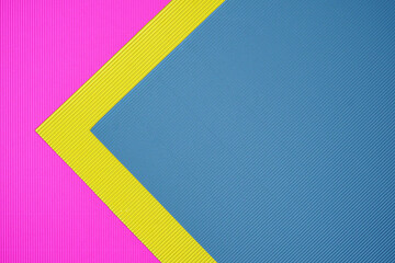 Blue, pink and yellow three tone color paper background with stripes. Abstract background modern hipster futuristic. Texture design