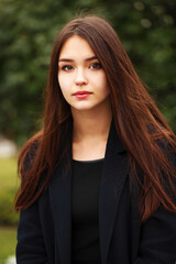 Wall Mural - Young beautiful brunette girl in the autumn park