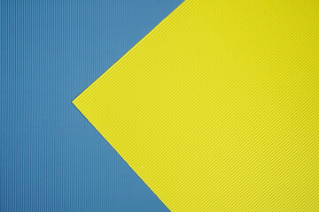 Blue and yellow two tone color paper background with stripes. Abstract background modern hipster futuristic. Texture design