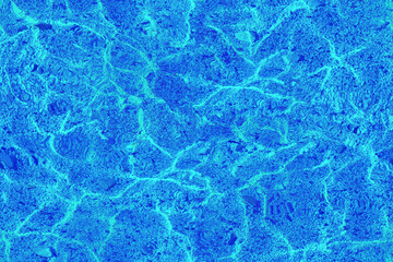  Abstract natural seamless texture. Shallow water, stone beach. Blue color toning