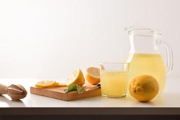 Wall Mural - Jug and glass with freshly squeezed lemon juice isolated white