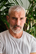 © Antonio Ovejero Diaz/Westend61 - Handsome mature man with white hair and beard at home