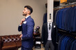 © Antonio Ovejero Diaz/Westend61 - Man trying on blue pinstripe suit in tailors boutique