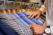 © Antonio Ovejero Diaz/Westend61 - Customers hands browsing shirts on rack in tailors boutique