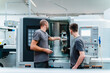 © Daniel Ingold/Westend61 - Engineer showing machine part to trainee while working at industry