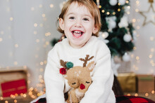 Close-up Of Cute Baby Girl Laughing While Sitting At Home During Christmas