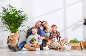 Wall Mural - Cheerful family sitting of floor in new apartment