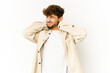 © Asier - Young arab man on white background suffering neck pain due to sedentary lifestyle.