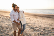 © Uwe Umst√§tter/Westend61 - Romantic young couple walking at beach during sunny day