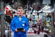 © Daniel Ingold/Westend61 - Mature engineer holding digital tablet while standing in industry