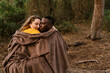 © Ezequiel Gim√©nez/Westend61 - Woman wrapped in blanket with man resting while sitting at forest