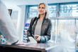© Mareen Fischinger/Westend61 - Smiling customer making payment through smart phone at checkout counter in chemist shop