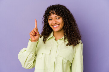 Wall Mural - Young african american afro woman isolated showing number one with finger.