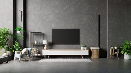 TV on cement stan in modern living room with lamp,table,flower and plant on cement wall background.