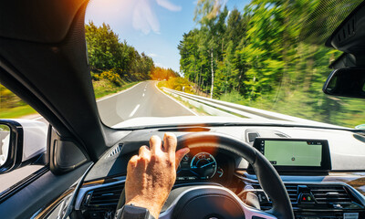 hands of car driver on steering wheel, road trip, driving on highway road