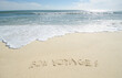© Chris  Hackett/Tetra Images - Bon Voyage' note on sand