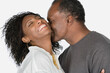 © Rob Lewine/Tetra Images - Studio portrait of mature couple kissing