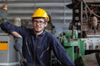 © nikomsolftwaer - Portrait of a worker in a factory. Portrait of industrial worker indoors in factory. Young technician with hard hat.