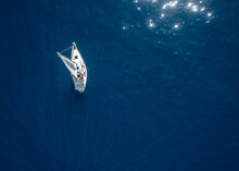 Aerial View Of A Small Sailing Boat Sailing In Mediterranean Sea Calm Water Off The Spanish Coasts. Spain.