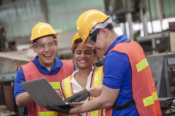 Male and Female Industrial Engineers Talk with Factory Worker while Using Laptop. industrial man engineer with laptop in a factory,