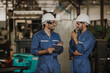 © nikomsolftwaer - Two people working. Male Industrial Engineers Talk with Factory Worker while Using tablet.
