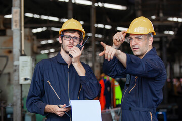 two workers at an industrial plant. working together manufacturing activities.. worker and engineer 