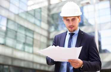 Portrait of cheerful man working outdoors and talking phone