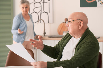 Poster - Stressed senior couple in debt at home