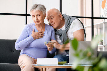 Sticker - Stressed senior couple counting money at home