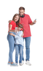 Poster - Happy family with mobile phones and headphones on white background