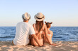 © Pixel-Shot - Happy family sitting on sea beach