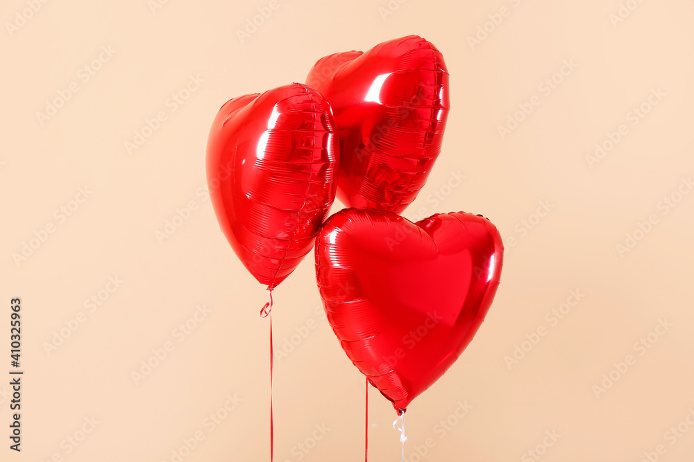 Heart shaped air balloons on color background