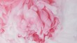 White and pink acrylic paint mixed in water . Slow motion