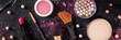 Makeup panorama, shot from above on a dark background. Lipstick, brushes, pearls etc