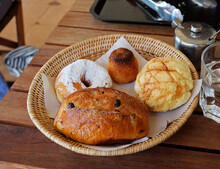 Basket Of Japanese Melon Bun, Coconut Roche, Sugar Icing Donut And Sweet Raisin Bun